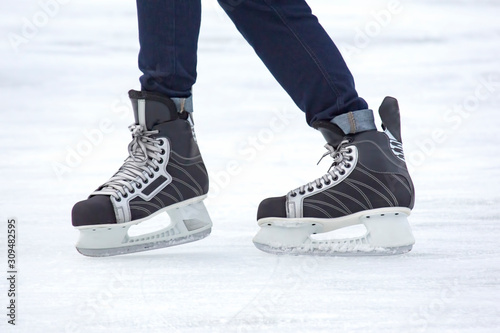 man actively skates on an ice rink. Hobbies and sports. Vacations and winter activities.