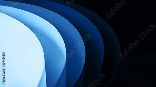 Trendy multicolor paper background from a cardboard of different classic blue colors.