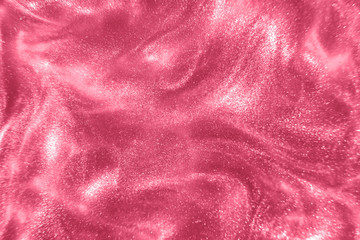 Abstract elegant, detailed pink glitter particles flow with shallow depth of field underwater. Holiday magic shimmering luxury background. Festive sparkles and lights. de-focused.