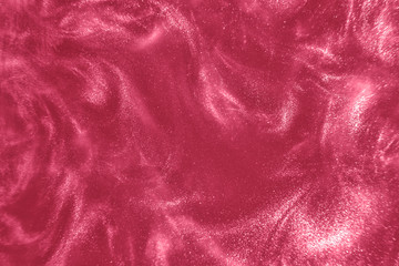Abstract elegant, detailed pink glitter particles flow with shallow depth of field underwater. Holiday magic shimmering luxury background. Festive sparkles and lights. de-focused.