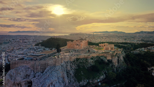 Aerial drone panoramic photo of beautiful sunset with golden colours and clouds over iconic Acropolis hill and Masterpice of Western ancient civilisation - the Parthenon, Athens, Attica, Greece photo