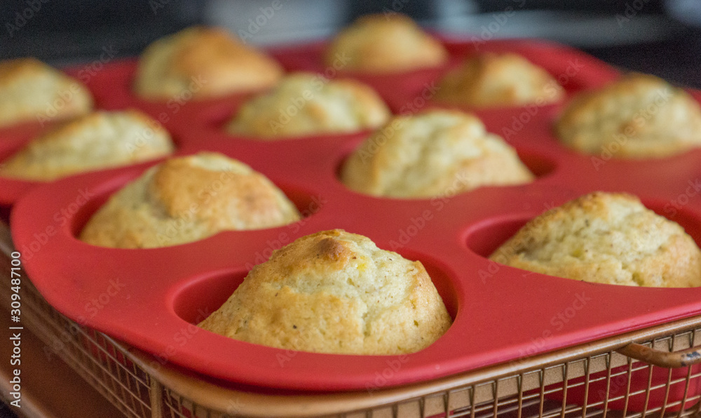 Freshly baked delicious banana nut muffins in a red tray. Fresh from the oven. Freshly baked delicious banana nut muffins in a red tray. Fresh from the oven.