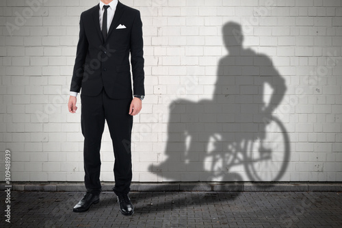 Businessman Standing With Shadow Of A Disables Man photo