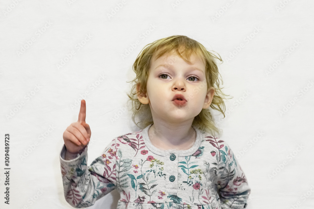 Little girl of three years old, looking at the camera and smiling.Defocused image. Little girl of three years old, looking at the camera and smiling.Defocused image.
