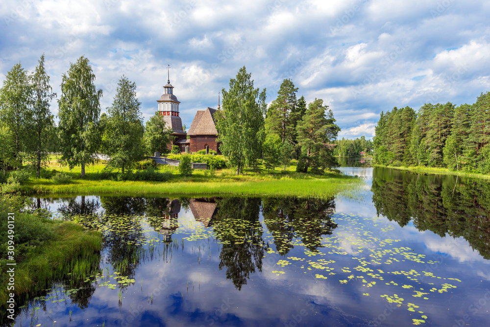Old wooden church of Petajavesi village is a part of natural environment of lake and forests. Jyvaskyla region in Central Finland.