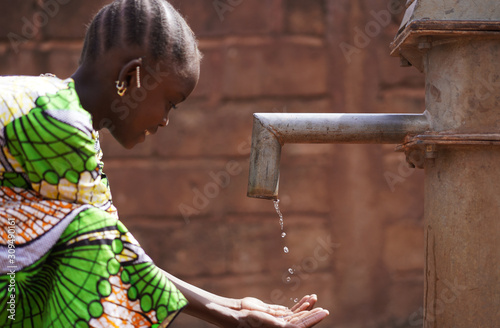 Close Up of African Black Girl Washing Herselft Outdoors