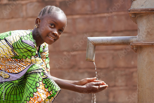 Water symbol of African Black Girl Kid Child Washing and Drinking photo
