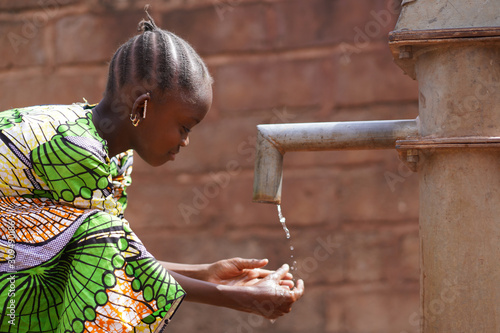 Candid Washing Hands with Fresh Water Climate Change Symbol photo
