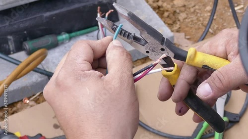 Technician strips and prepares wires for connection - close-up HD