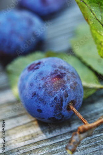 delicious fresh plums on a wooden table