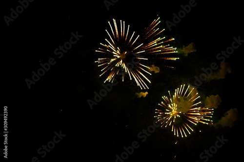 Yellow fireworks on the right side on a black background.