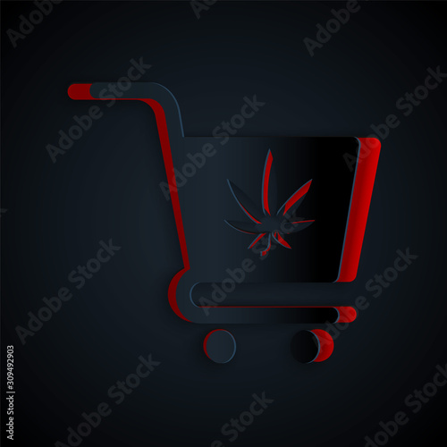 Paper cut Shopping cart with marijuana or cannabis leaf icon isolated on black background. Online buying. Delivery service. Supermarket basket. Paper art style. Vector Illustration