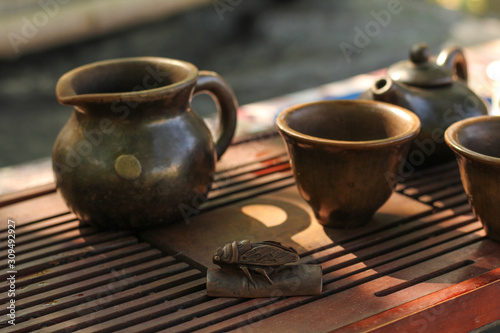 Tea ceremony. Teapot and bowls with Chinese tea on a wooden table. Drink, traditional, japan, health, beads, buddha, asia, asian, background, bamboo, beverage