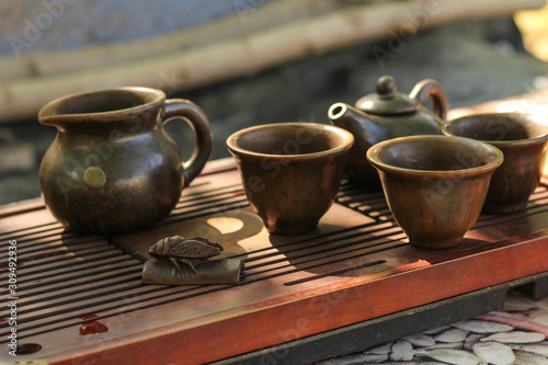 Tea ceremony. Teapot and bowls with Chinese tea on a wooden table. Drink, traditional, japan, health, beads, buddha, asia, asian, background, bamboo, beverage © Alexandr