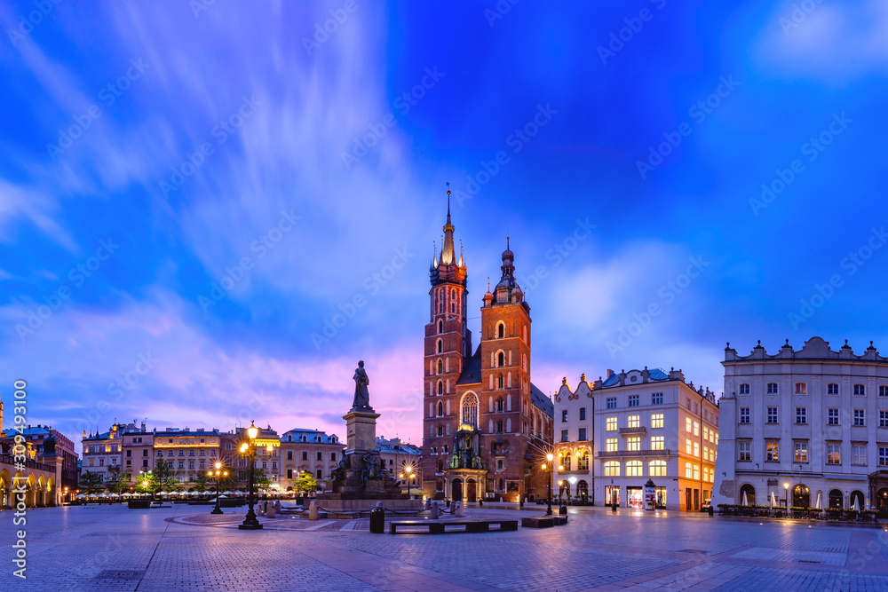 Medieval Main market square with Basilica of Saint Mary and Cloth Hall in Old Town of Krakow at sunrise, Poland