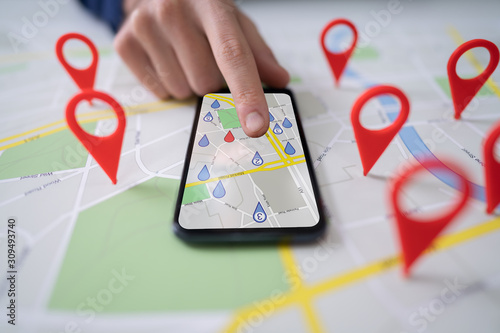Fototapeta Naklejka Na Ścianę i Meble -  Map With Red Location Marker And Mobile Phone