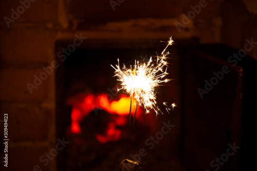 Bengal fire and sparks macro photo festive bokeh background Christmas and New Year