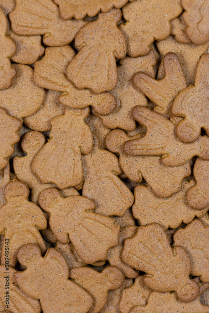 Fototapeta premium Gingerbread figures for background. Christmas decor. Man and woman with smiling faces. Vertical