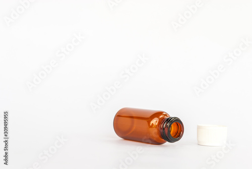 blank packaging prescription  brown glass supplement medicine white pills isolated on white background 