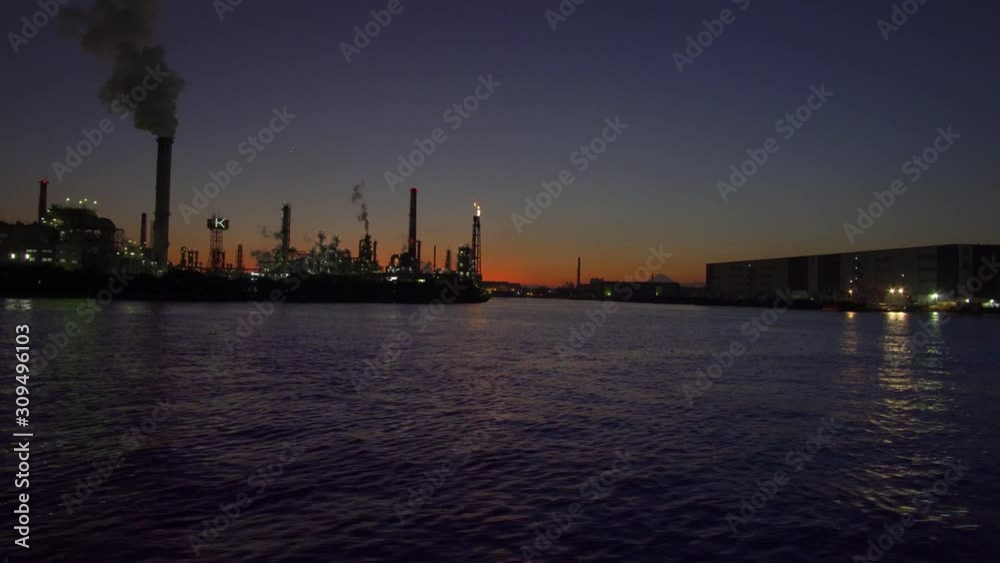Kanagawa,Japan-December 1, 2019: Flare stack observed from canal in Tokyo at night. Kanagawa,Japan-December 1, 2019: Flare stack observed from canal in Tokyo at night.