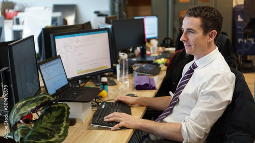 Male caucasian worker professional at his computer desk in an office in London, United Kingdom. photo