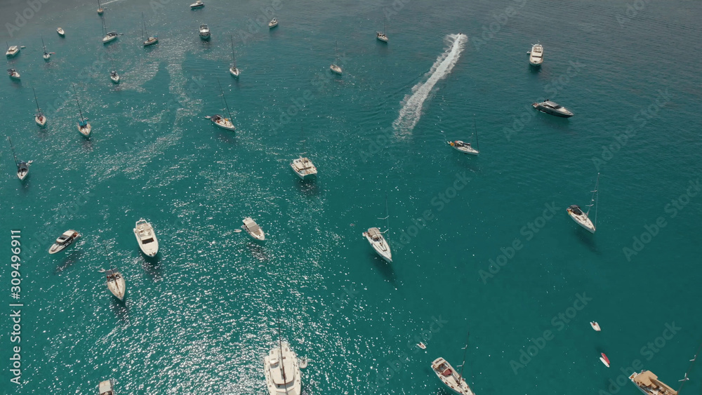 Aerial View of many yachts in a bay on Formentera island. Cala Saona bay drone footage. Yachting in the Balearic islands Aerial View of many yachts in a bay on Formentera island. Cala Saona bay drone footage. Yachting in the Balearic islands