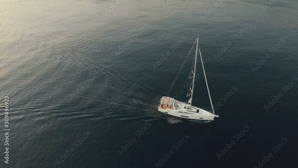 Fototapeta premium Aerial View of yacht near rocky island of Mallorca. Drone footage of yachting around Balearic islands in the mediterranean sea 