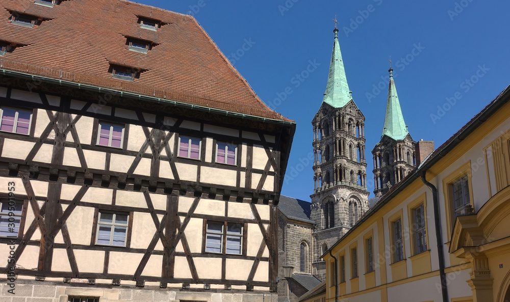 Towers of the Bamberg cathedral peeking out behind typical medieval buildings.
