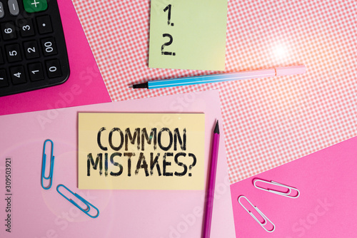 Text sign showing Common Mistakes Question. Business photo text repeat act or judgement misguided making something wrong writing equipments with stationary and plain note paper placed on the table