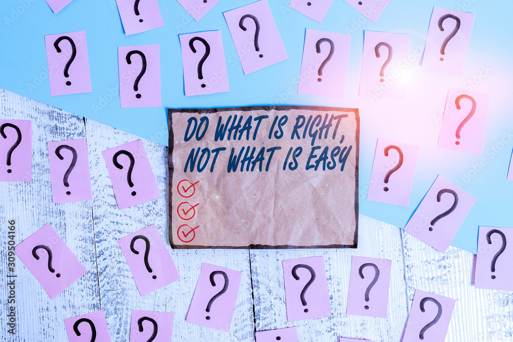 Writing note showing Do What Is Right Not What Is Easy. Business concept for willing to stand up for what is right Scribbled and crumbling papers with thick cardboard above wooden table