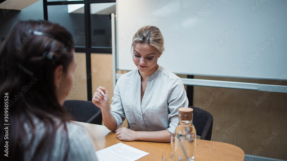 Job interview or business meeting face - to-face. Two business women at a meeting Job interview or business meeting face - to-face. Two business women at a meeting