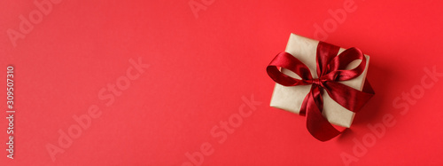 Small Christmas gift box on red background