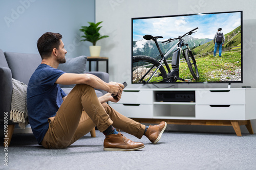 Man Using Digital Tablet For Watching Television