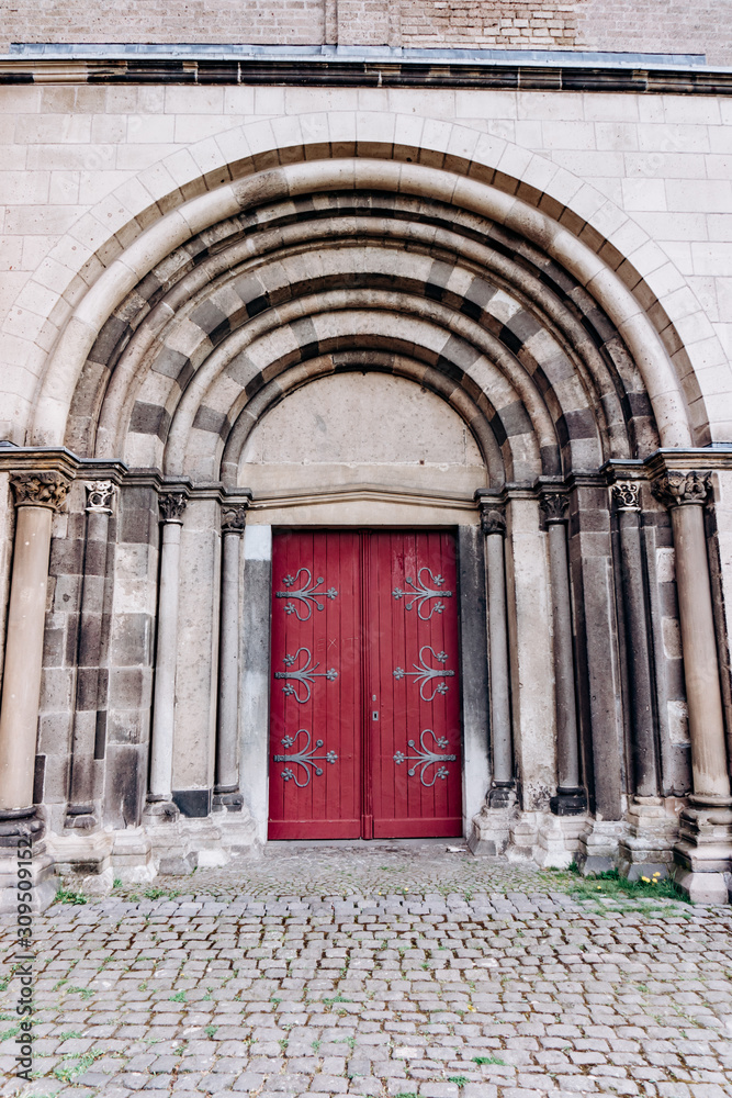 Beautiful doors in the Romanesque style with a big arch.