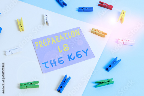 Conceptual hand writing showing Preparation Is The Key. Concept meaning it reduces errors and shortens the activities Colored clothespin paper reminder with yellowblue background