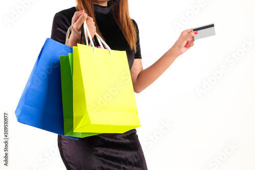 The modern lifestyle of a woman, she holds credit cards, cards and shopping bags. She is currently spending a bill to make purchases and pay off debt on the internet