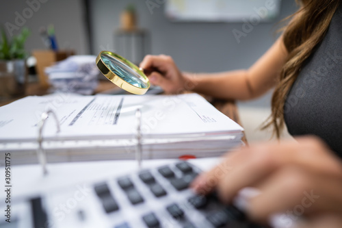 Businesswoman Inspecting Receipts In Office