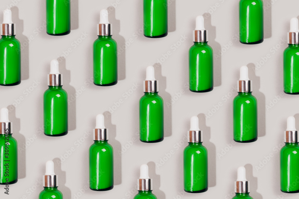 Pattern made with green care cosmetics bottle. Flat lay style. Pattern made with green care cosmetics bottle. Flat lay style.