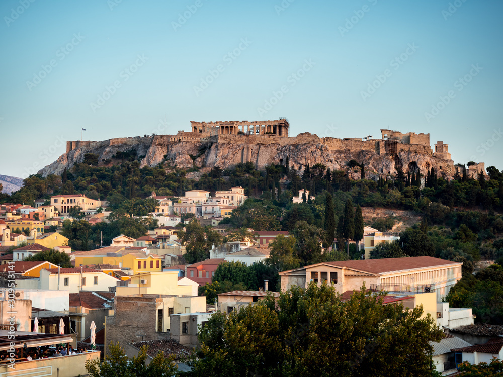 Looking across the Athena Athens cityscape in Greece at the Acropolis at sunset