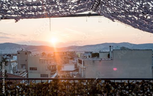 Looking across the Athena Athens cityscape in Greece at the Acropolis at sunset photo