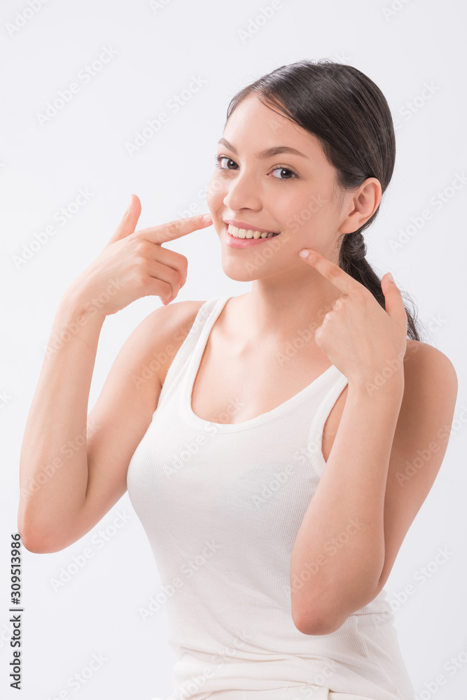 beautiful young woman with clean fresh skin touch own face . facial treatment . cosmetology , beauty and spa . beautiful young woman with clean fresh skin touch own face . facial treatment . cosmetology , beauty and spa .