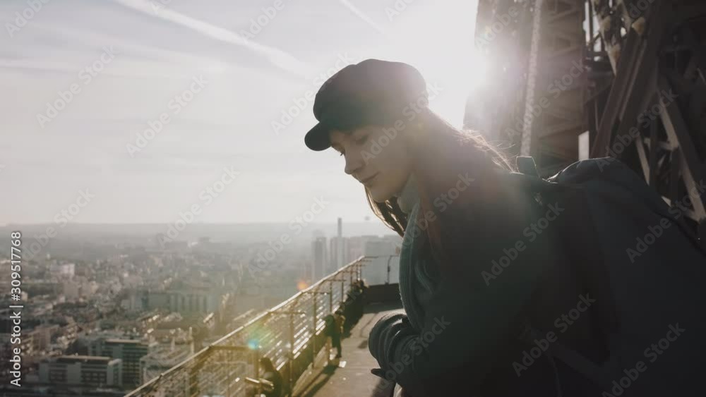 Side view young beautiful European woman watching gorgeous sunset city panorama on top of Paris Eiffel Tower slow motion Side view young beautiful European woman watching gorgeous sunset city panorama on top of Paris Eiffel Tower slow motion