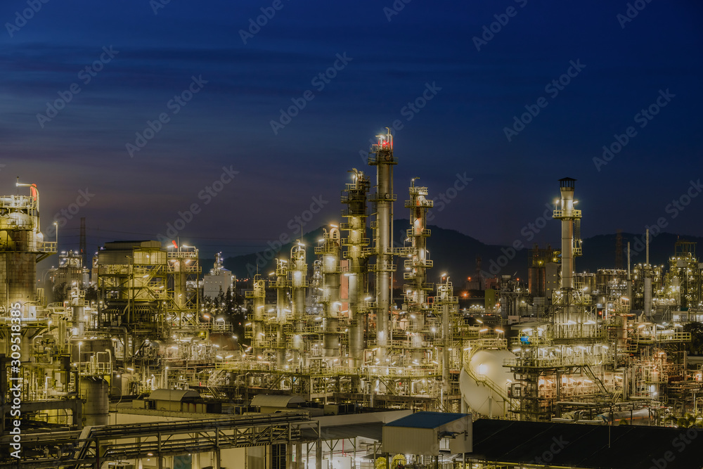 Twilight sky with petrochemical industry estate, glitter lighting of petrochemical industrial on blue sky twilight background