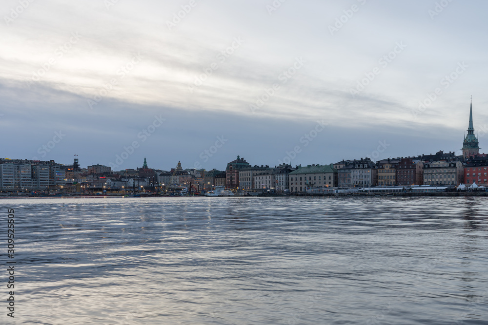 Winter landscapes of Stockholm old city during Christmas, sunset view of Stockholm harbor and big Christmas tree