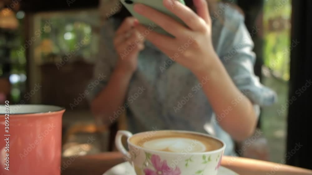 Woman taking photo of coffee by smartphone in cafe. Woman taking photo of coffee by smartphone in cafe.