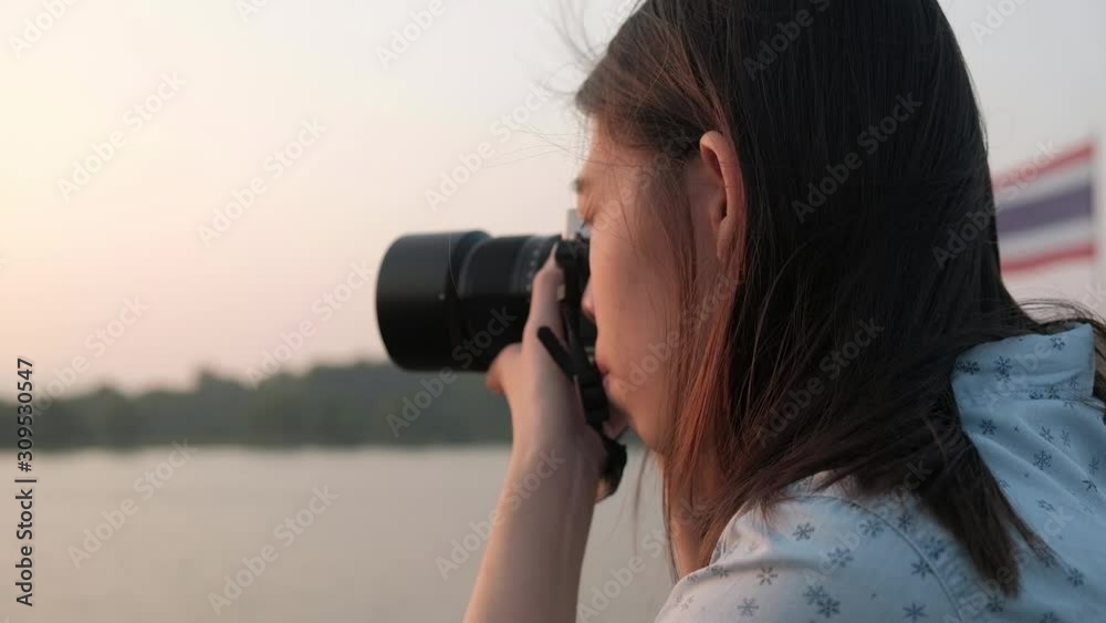 Asian woman take a photo with her camera. Asian woman take a photo with her camera.