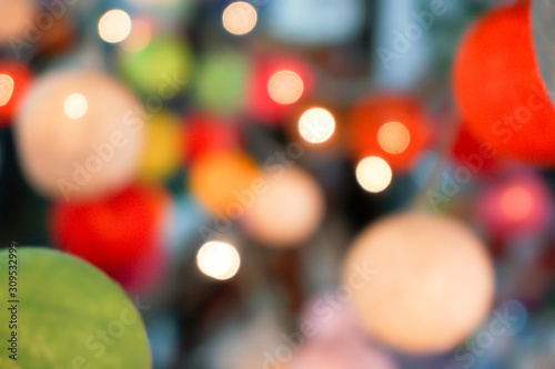 Blurred and bokeh reflection lighting of lights decorating the Christmas tree around beautifully.