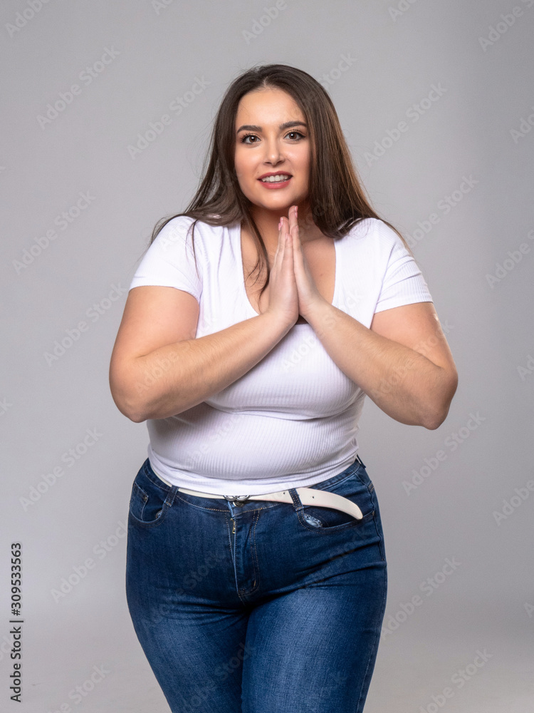 Plus Size Model with long hair posing in studio Plus Size Model with long hair posing in studio