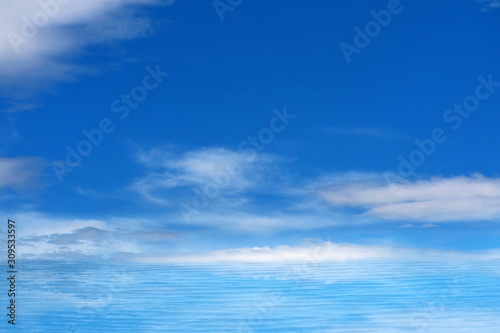 reflection white pure heap cloud in the blue sky and sunlight on sea surface