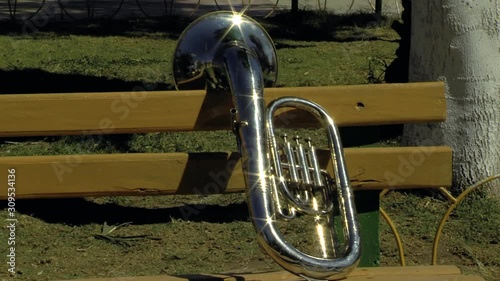 A Baritone Horn over a Park Bench. Zoom In.  photo